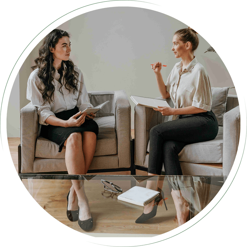 Two women having a friendly conversation in a modern living room.